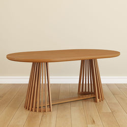 Modern wooden dining table with unique slatted base design on hardwood floor.
