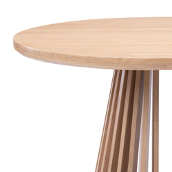 Round wooden dining table with unique slatted base design.