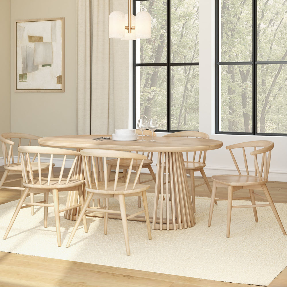 Modern dining room with oak table and chairs, featuring large windows and beige decor.