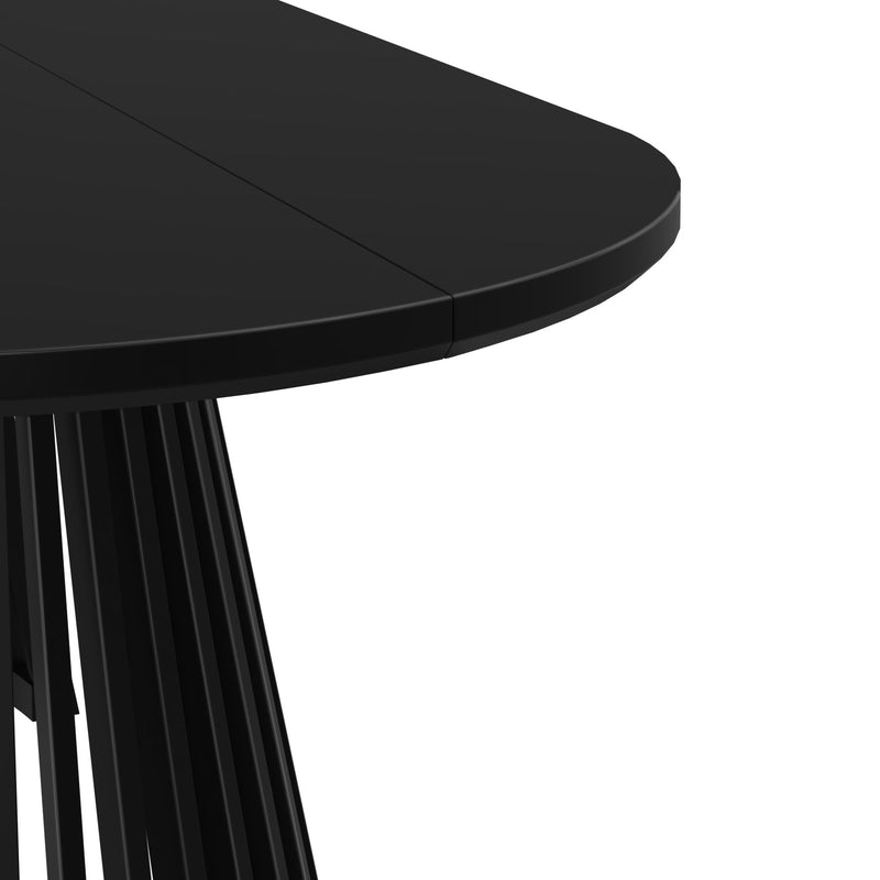 Modern black round dining table with sleek pedestal base.