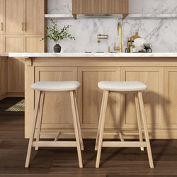 Modern kitchen with wooden cabinets and two white bar stools.