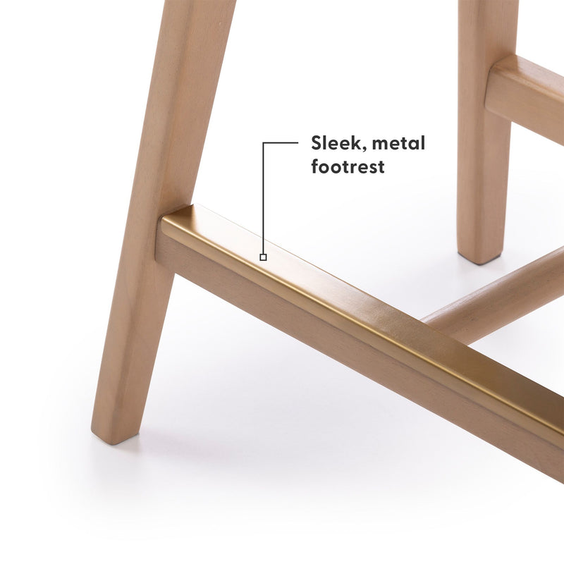 Bar stool with sleek, metal footrest and wooden legs on a white background.