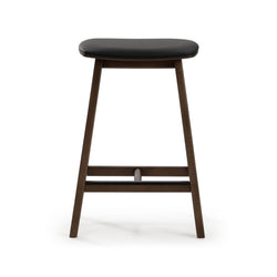 Modern walnut counter-height bar stool with black leather cushion, angled legs and footrest for kitchen island seating.