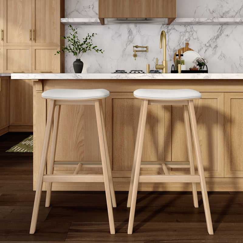 Modern kitchen with wooden cabinetry, marble backsplash, and contemporary bar stools.