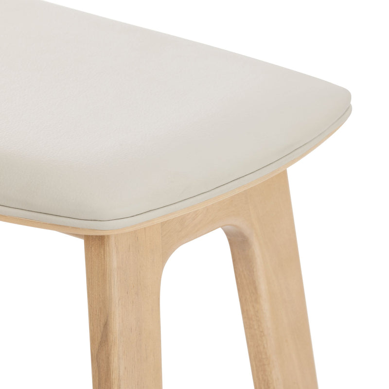 Light wooden chair with white cushioned seat, modern minimalist furniture design.