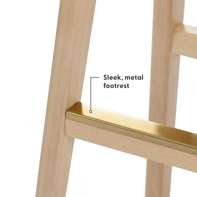 Natural wood chair with a sleek metal footrest, close-up detail.