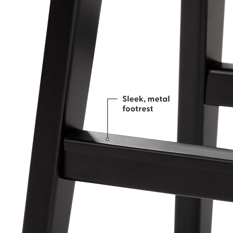 Close-up of sleek metal footrest on black wooden bar stool — durable powder-coated finish, modern kitchen counter stool detail