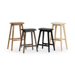 Four modern wooden bar stools in mixed wood and black finishes with contoured seats and footrests, counter-height seating for kitchen islands and bars