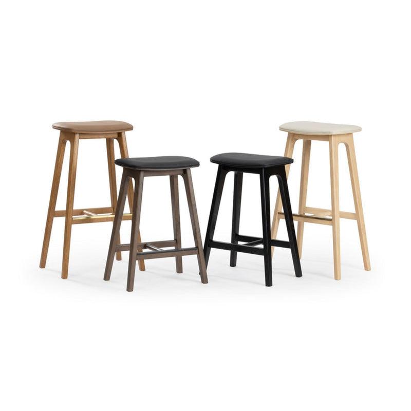 Four modern wooden bar stools in mixed wood and black finishes with contoured seats and footrests, counter-height seating for kitchen islands and bars