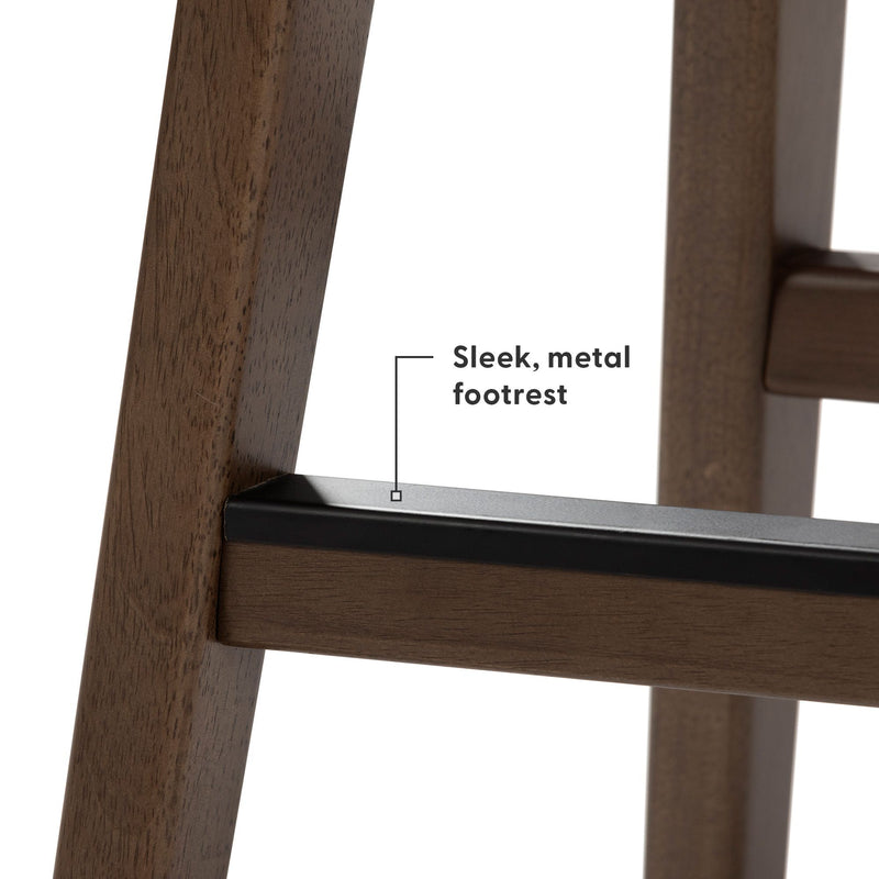 Close-up of walnut wood bar stool leg and sleek black metal footrest, modern farmhouse bar stool detail