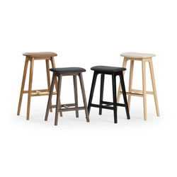 Four modern wooden bar stools with padded seats in various colors, perfect for kitchen and dining areas.