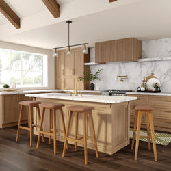 Modern kitchen interior with wooden cabinets, marble countertops, and island seating.