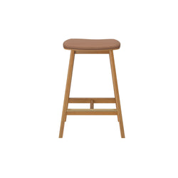 Mid-century modern backless wood bar stool with tan leather padded seat, natural oak tapered legs and footrest — ideal kitchen island or counter seating