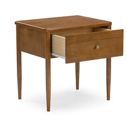 Mid-century modern warm walnut bedside table with tapered legs, single open drawer and round metal knob for bedroom storage