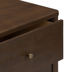 Close-up of brown wooden nightstand with partially open drawer and brass knob, modern bedroom dresser storage detail