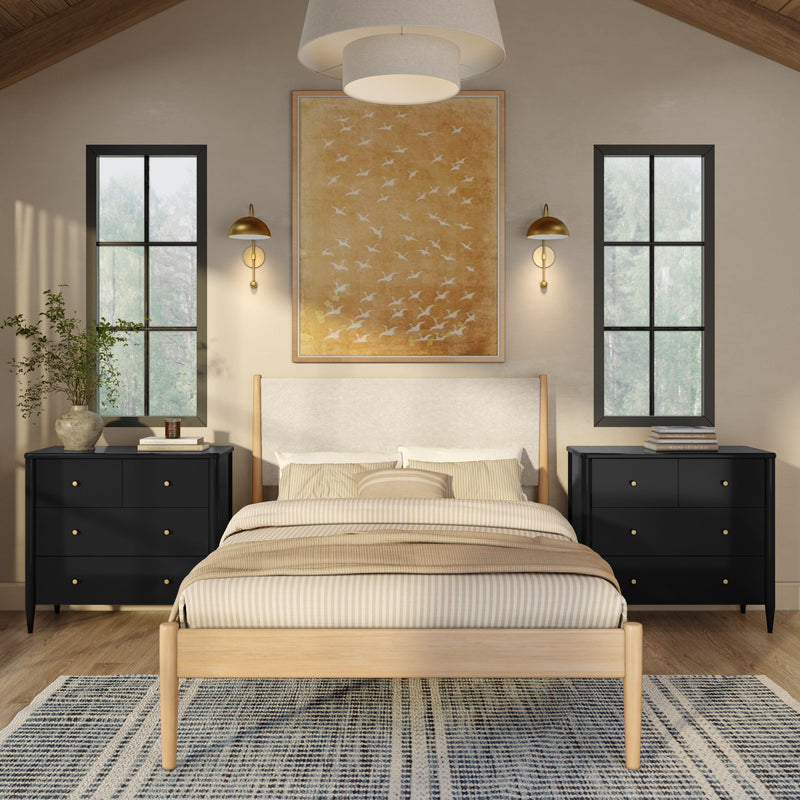 Minimalist bedroom with light wood bed, striped beige bedding, black nightstands, gold sconces, large windows and abstract wall art