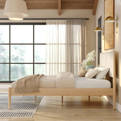 Minimalist Scandinavian bedroom with natural wood platform bed, neutral striped bedding, large black-framed window and sheer curtains