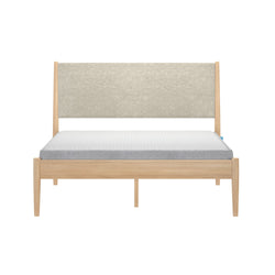Light oak platform bed with beige upholstered headboard and white quilted mattress with gray side panels, modern minimalist Scandinavian bedroom furniture product image on white background