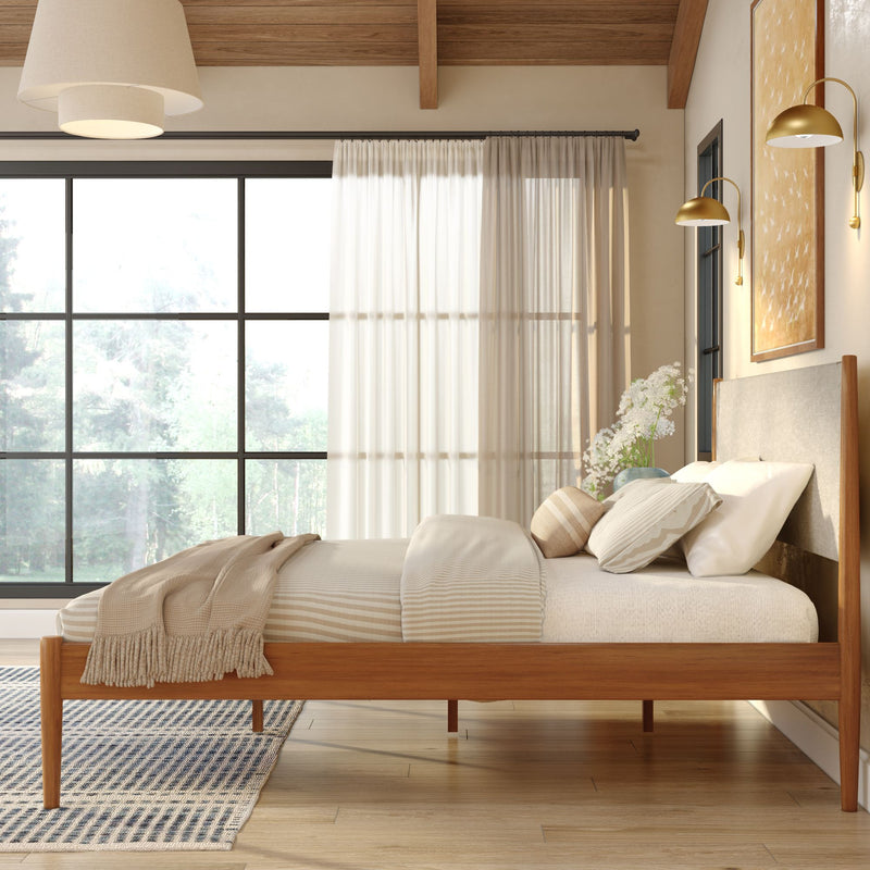 Modern Scandinavian bedroom with wooden platform bed, neutral bedding and throw, large black-framed window with sheer curtains and natural light