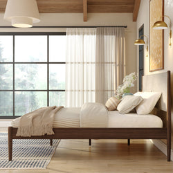 Modern minimalist bedroom with walnut wooden bed frame, neutral cozy bedding, large grid window and abundant natural light