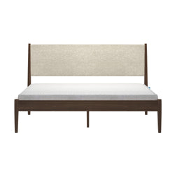 Mid-century modern walnut platform bed with beige upholstered headboard, white mattress and tapered wooden legs