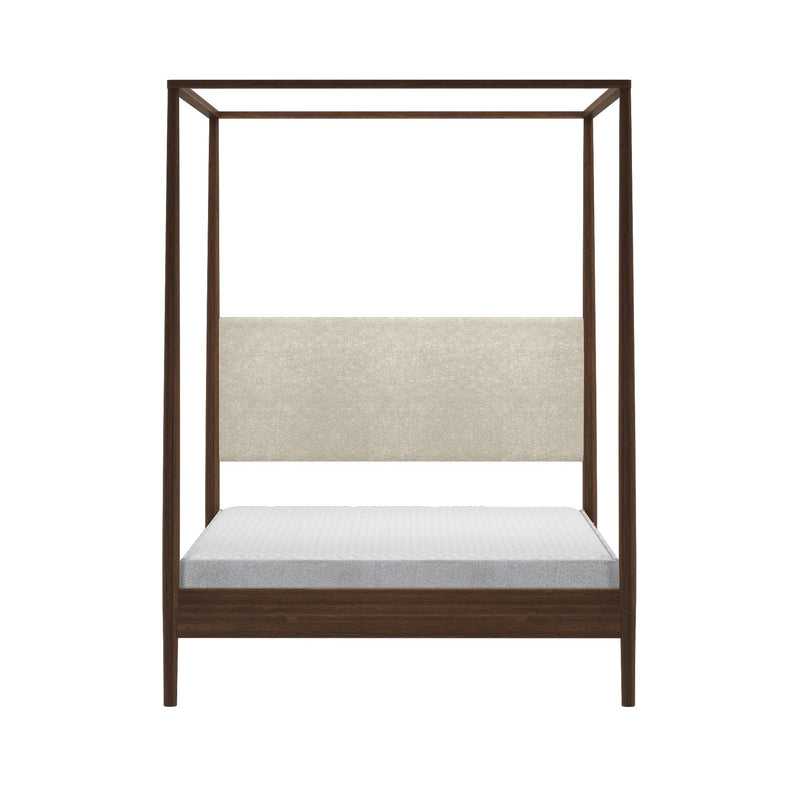 Modern walnut four-post canopy bed with beige upholstered headboard and low platform base, white mattress, isolated on white background