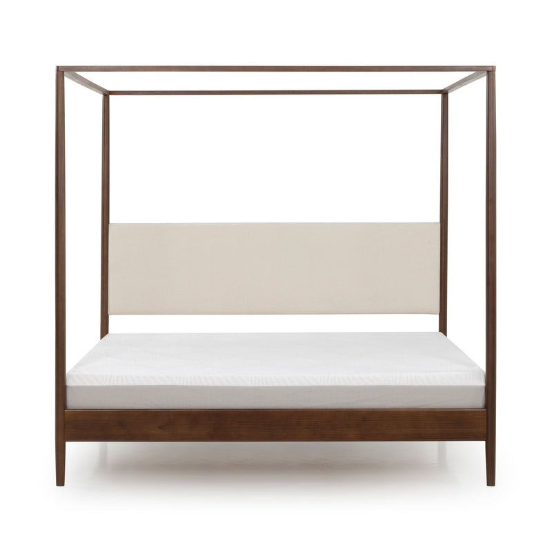 Modern walnut four-poster canopy bed with beige upholstered headboard and white mattress, minimalist bedroom furniture