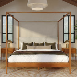 Minimalist bedroom interior with wooden four‑poster canopy bed, neutral white and beige bedding, olive accent pillows, mid-century nightstands with brass lamps and large windows providing natural light