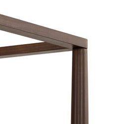 Close-up of stained brown solid-wood canopy bed frame corner with rounded post, modern wooden furniture detail