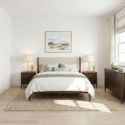 Minimal modern neutral bedroom with upholstered headboard, wooden nightstands, brass lamps, jute rug and soft natural light