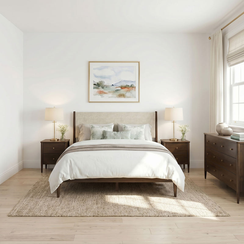 Minimal modern neutral bedroom with upholstered headboard, wooden nightstands, brass lamps, jute rug and soft natural light