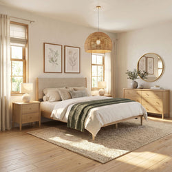 Cozy neutral Scandinavian bedroom with wooden bed and dresser, rattan pendant light, round mirror, botanical wall art, textured rug and natural light