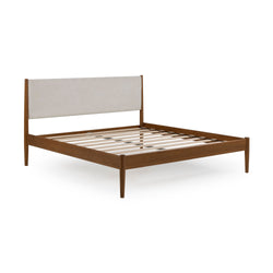 Mid-century modern walnut wood bed frame with beige upholstered headboard, slatted platform base and tapered legs on white background