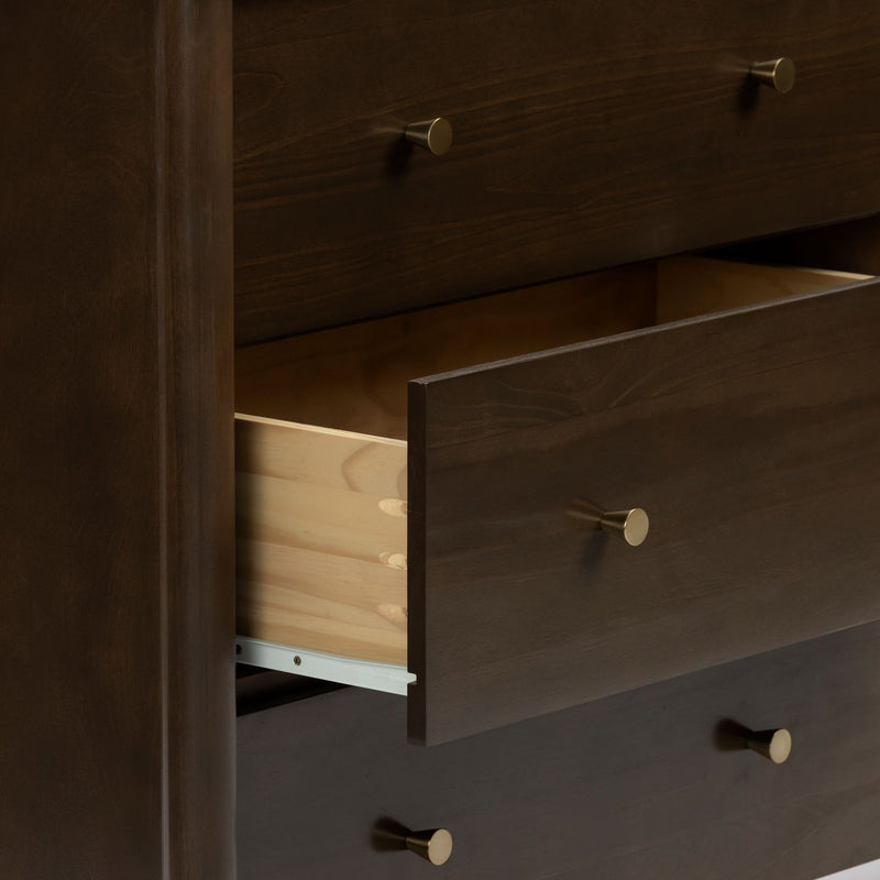 Dark wood chest of drawers with brass knobs and a partially open drawer showing dovetail joints and light wood interior
