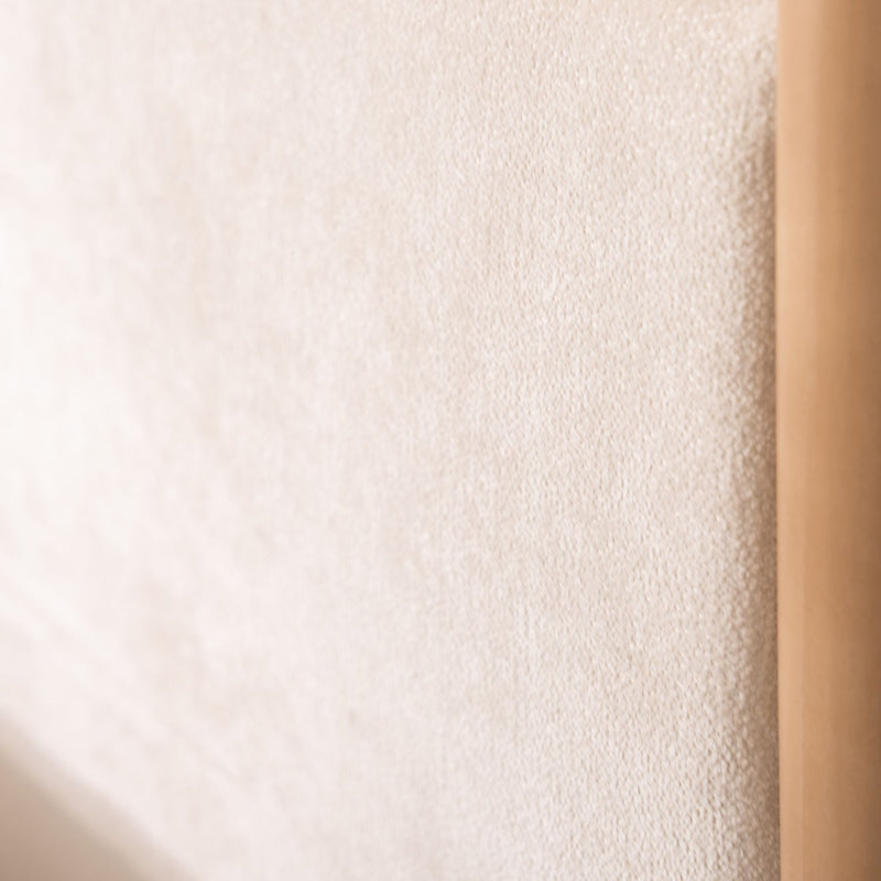 Close-up of beige textured towel hanging on a wooden rack, soft terry fabric ideal for minimalist bathroom and neutral home decor