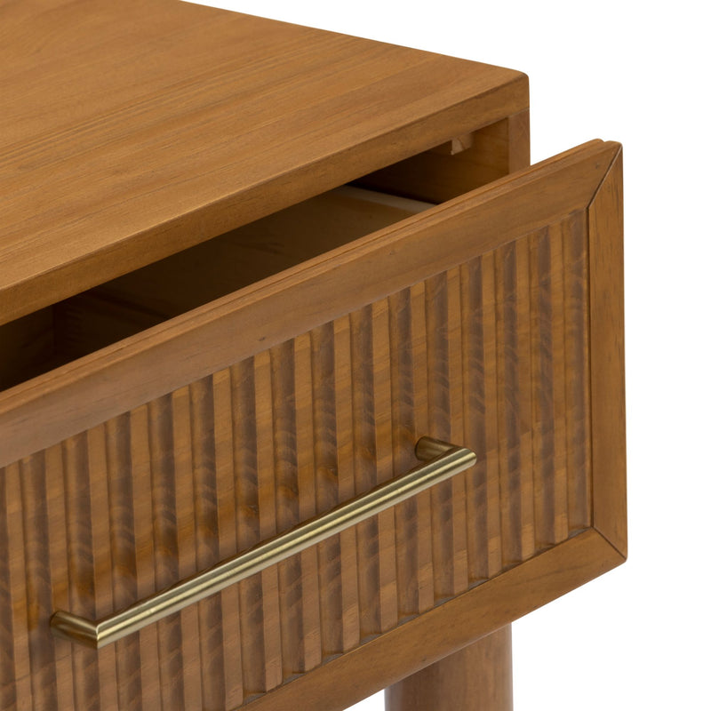 Close-up of mid-century modern wooden nightstand drawer with fluted front detail and brass bar handle in warm honey finish