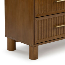 Mid-century modern walnut-finish dresser corner with ribbed fluted drawer fronts, brass bar handle, and cylindrical wooden legs