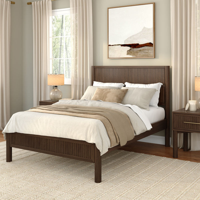 Cozy modern farmhouse bedroom with dark wood bed frame, neutral beige linen bedding, floor-to-ceiling curtains, wooden nightstand with glass lamp, abstract framed wall art and woven rug