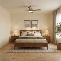 Modern minimalist bedroom with wooden platform bed, neutral linen bedding, ceiling fan with integrated light, matching bedside lamps, hardwood floors and sheer curtains