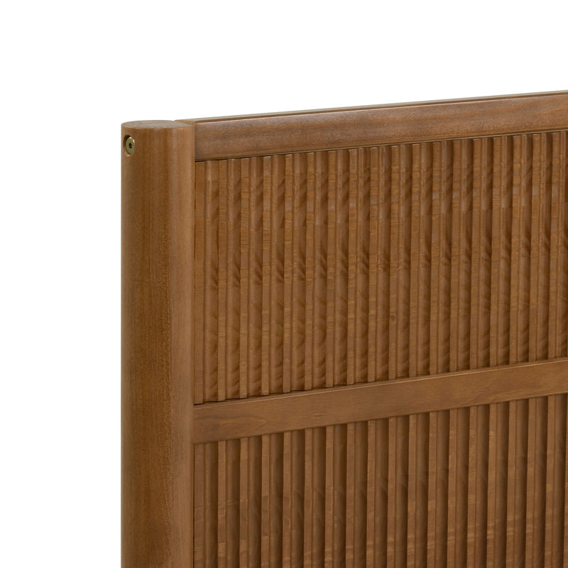 Close-up of mid-century modern wooden headboard with vertical fluted grooves and warm walnut finish, textured bedroom furniture detail