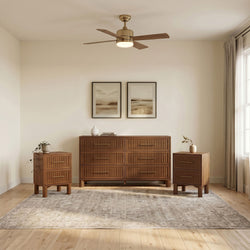 Modern brass ceiling fan with integrated LED light above wooden mid-century dresser and matching nightstands in a neutral minimalist bedroom