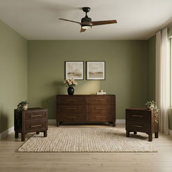 Modern living space with three-blade wood ceiling fan, olive green accent walls, mid-century walnut dresser, framed art, vases and textured rug
