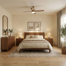 Cozy mid-century modern bedroom with slatted wooden bed and dresser, neutral bedding, bedside lamps, ceiling fan, framed art, indoor plants, sheer curtains, and light wood flooring