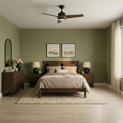 Mid-century modern master bedroom with olive-green accent wall, wooden platform bed and matching nightstands, beige bedding, textured area rug, vase of flowers on dresser, three-blade ceiling fan and soft natural light