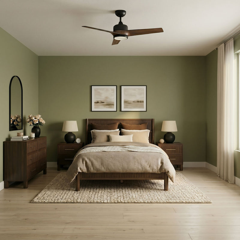 Mid-century modern master bedroom with olive-green accent wall, wooden platform bed and matching nightstands, beige bedding, textured area rug, vase of flowers on dresser, three-blade ceiling fan and soft natural light