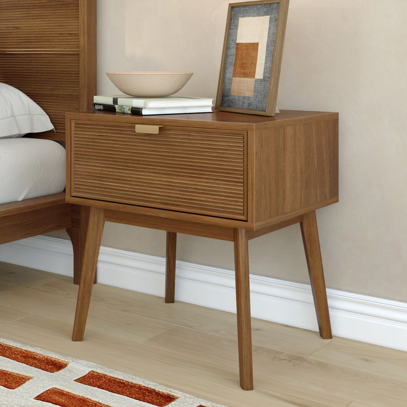 Mid-century modern wooden bedside table with slatted drawer, decorative bowl, stacked books and framed abstract art for neutral bedroom decor