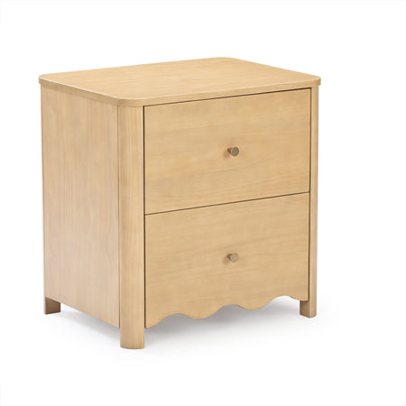 Natural light wood three-drawer nightstand bedside table with brass knobs, scalloped base and tapered legs in a modern farmhouse style