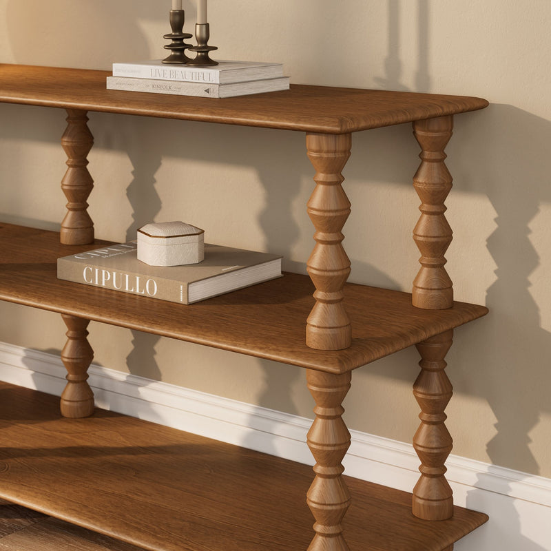 Oak wooden console shelf with turned spindle legs, stacked neutral coffee table books and small decorative box in warm minimalist living room