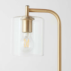 Modern brass lamp with clear cylindrical glass shade and LED filament bulb - minimalist bedside or living room lighting