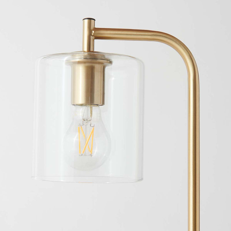Modern brass lamp with clear cylindrical glass shade and LED filament bulb - minimalist bedside or living room lighting